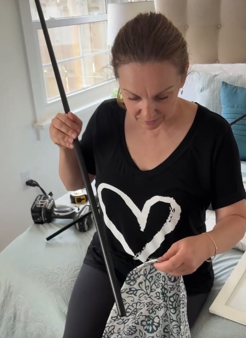 Fitting a curtain rod in a bedroom